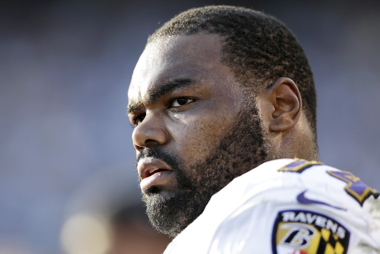 In this Nov. 25, 2012 photo, Baltimore Ravens tackle Michael Oher sits on the sidelines during the second half of an NFL football game against the San Diego Chargers, in San Diego. Oher and his adoptive family were depicted in the book and movie, "The Blind Side." Oher will play in his first Super Bowl on Sunday, Feb. 3, 2013, in New Orleans, which is where his adoptive father grew up and went to high school with author Michael Lewis, who wrote "The Blind Side." (AP Photo/Gregory Bull)